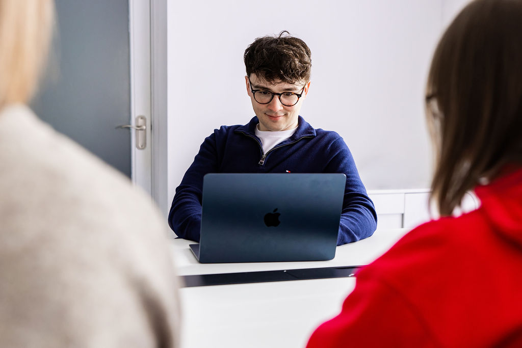 A member of the Schudio team working at a laptop