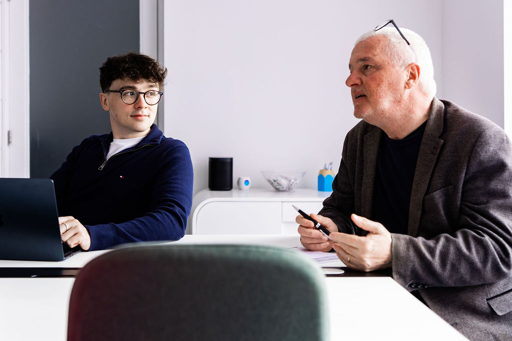 A Schudio colleague listening while another talks through a point